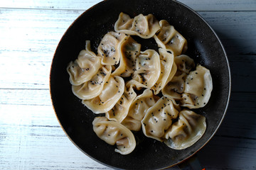 A plate of fried dumplings sprinkled with sesame