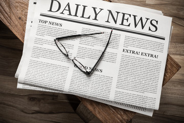 Newspaper with the headline News with glasses on wooden table, Daily Newspaper mock-up concept