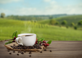 Hot coffee cup with fresh organic red coffee beans and coffee roasts on the wooden table and the black background with copyspace for your text.