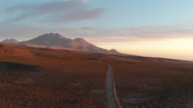 Drone shot of a dirt road at sunset in the Atacama Desert, Chile, South America