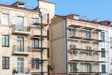 renovation of old building facade. metal scaffolding near wall