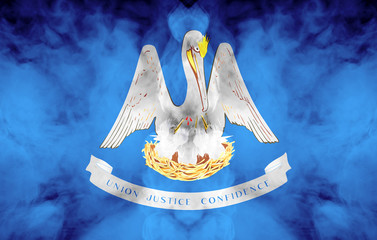 The national flag of the US state Louisiana in against a gray smoke on the day of independence in different colors of blue red and yellow. Political and religious disputes, customs and delivery.