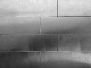 Shiny silver plate connect as brick on the wall