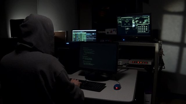 Computer hacker typing in code