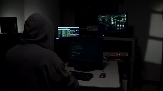 Computer hacker typing in code
