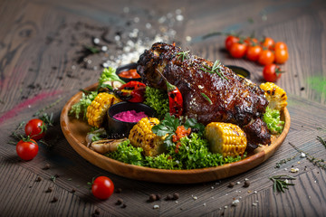 fried pork with vegetables and sauce on the plate