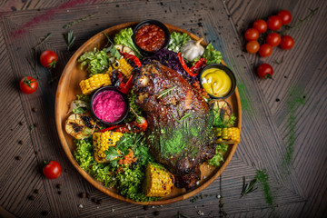 fried pork with vegetables and sauce on the plate