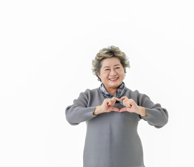 Happy Asian senior woman make her hand to be heart, love in the air isolate on white background