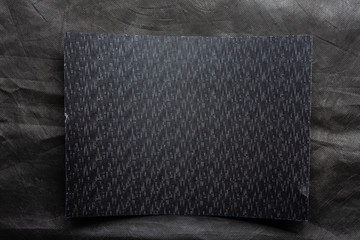 paper shit on dark grey textile background 