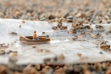 Miniature People, Miniature fishermen are fishing by boat