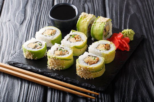Menu green dragon Japanese rolls with avocado, omelet, sesame and cucumber closeup. horizontal