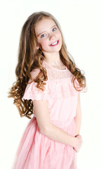 Portrait of adorable smiling little girl child in princess dress with curl hair standing isolated