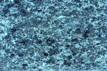 Vintage blue background. Rough painted wall of sapphire color. Imperfect plane of blue colored. Uneven old decorative toned backdrop of cyan tint. Texture of sapphirine hue. Ornamental stony surface.