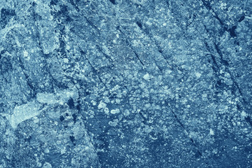 Vintage blue background. Rough painted wall of sapphire color. Imperfect plane of blue colored. Uneven old decorative toned backdrop of cyan tint. Texture of sapphirine hue. Ornamental stony surface.