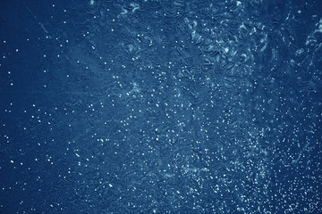 Vintage blue background. Rough painted wall of sapphire color. Imperfect plane of blue colored. Uneven old decorative toned backdrop of cyan tint. Texture of sapphirine hue. Ornamental stony surface.