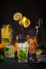 Still life of fresh fruit lemonades with splashing and freeze motion, close-up. Citrus refreshing summer beverage