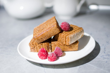 cake and raspberry on a white plate