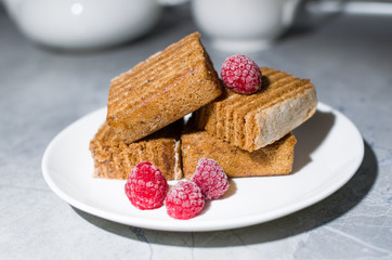 cake and raspberry on a white plate