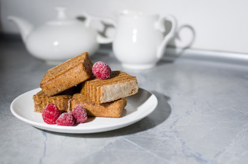 cake and raspberry on a white plate