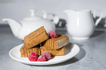 cake and raspberry on a white plate