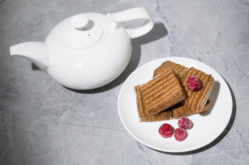 cake and raspberry on a white plate