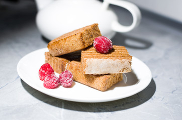 cake and raspberry on a white plate