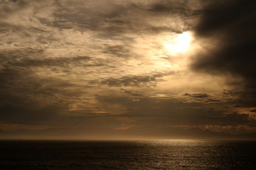 Dreamy cloudy sunset landscape over the ocean in summer.