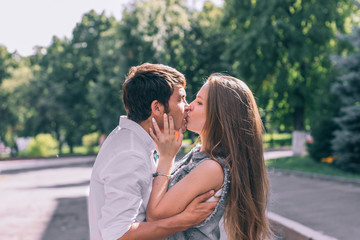 Stylish young funny hipster couple kiss
