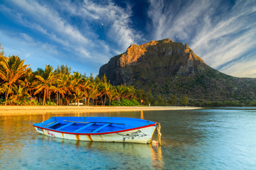 Fishing boat near the shore of the tropical island. Mauritius. - obrazy, fototapety, plakaty