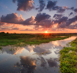 Beautiful sunset over the river. Country landscape.
