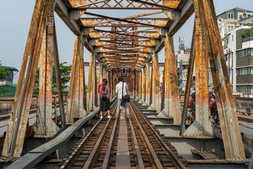 Railways on Long Bien ancient metal bridge with people taking photo on railways