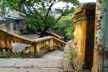 Old open outer stone staircase, steps of the old staircase with traces of weathering and destruction. Aged footpath in Hanoi city