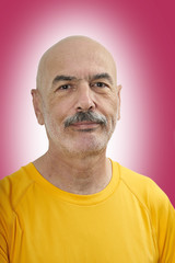 Obraz premium Portrait of Handsome Bald Mature Man on Color Background