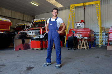 full length view of young male fire station mechanic