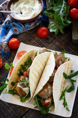 Delicious fresh homemade tortilla wrap with falafel and fresh salad on the table. Vegan tacos. Vegetarian healthy food.