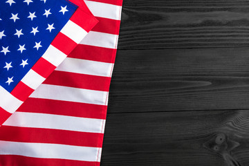 Fototapeta na wymiar American flag on a black wooden
