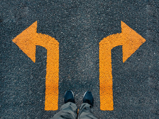 Man Standing on street road Arrow Direction Choice Left and Right traffic sign conceptual