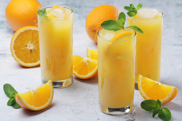 Glasses full of orange juice with ice