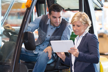 woman working with a forklift in a warehouse