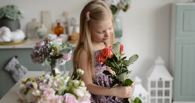 girl with a bouquet of flowers in the kitchen sitting on the table