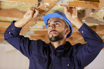 man working with ceiling