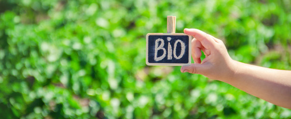 bio farm sign in the hands of a child. selective focus.