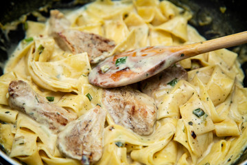 Food Concept Ready Cooked Tagliatelle Pasta with Onion, Steak Meat and Sour Cream .