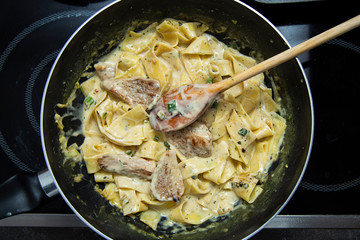Food Concept Ready Cooked Tagliatelle Pasta with Onion, Steak Meat and Sour Cream .
