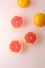 Ripe Grapefruit on pink flat lay