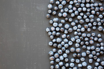 Ripe organic blueberries on a black background, top view. Summer berry. Flat lay, overhead, from above. Copy space.