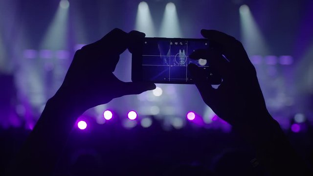 making photos with a smartphone on a live concert