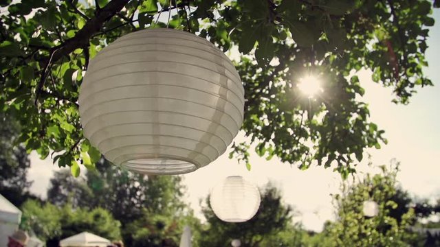 white round laterns hanging in sunlight