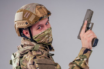menacing gaze army soldier holding a weapon and a mask