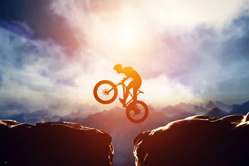 Rolgordijnen Man jumping with bike between two high mountains © Photocreo Bednarek